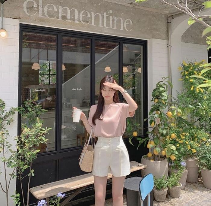 Sơ mi màu pastel tối giản nhưng không hề đơn điệu khi đi cùng quần short trắng ôm vừa vặn lấy phần eo. Công thức này rất hợp để tôn vòng hai, kéo dài chân và “ăn gian” tuổi cho bạn gái.