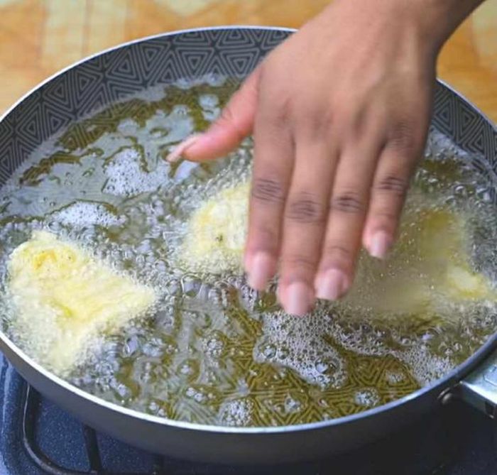 Các bạn làm lần lượt từng miếng cá một như trên rồi thả vào chảo dầu để rán. Lúc này, các bạn thử đưa tay lên mặt chảo sẽ thấy chảo cá rán không hề bị bắn một chút dầu nào ra ngoài.