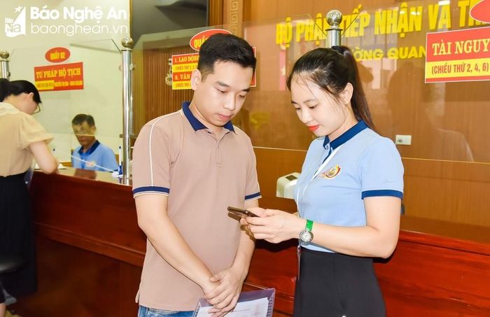  Cán bộ phụ trách lĩnh vực tư pháp hướng dẫn cho người dân thực hiện dịch vụ công trực tuyến liên thông. Ảnh: T.L 