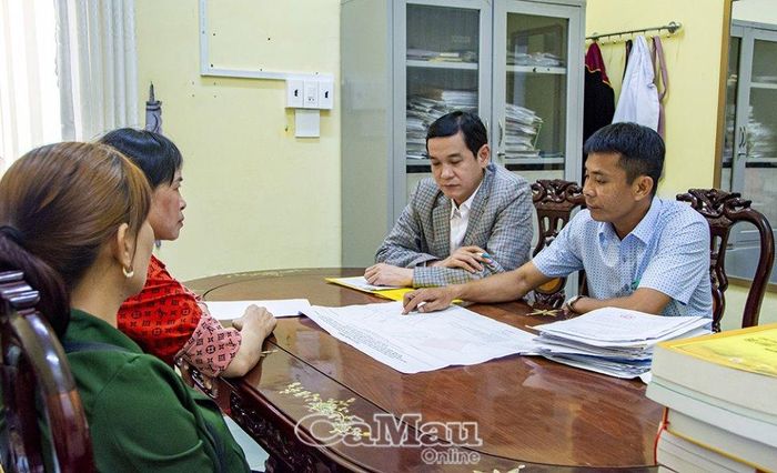 Anh Trần Hoàng Út (bìa phải) phối hợp với Thư ký Tòa án Nhân dân huyện Ngọc Hiển, gặp gỡ hòa giải vụ mua đất của ông Cọp.