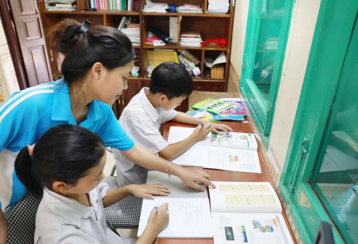 Hỗ trợ các em nhỏ làm bài tập về nhà.