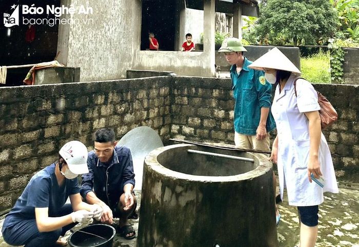Cán bộ y tế huyện Quỳ Châu kiểm tra nguồn nước sau lũ. Ảnh: Văn Trường