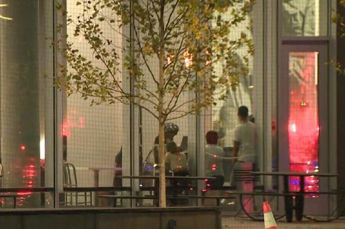Các sinh viên trú ẩn bên trong một căng tin. Ảnh: CBS News