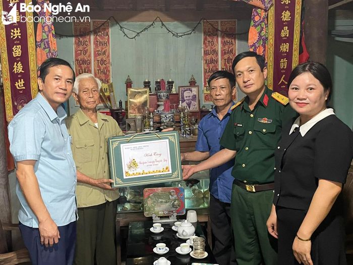  Lãnh đạo xã Nghĩa Lâm tặng quà cho đồng chí Nguyễn Thăng Long, 56 năm tuổi Đảng, trú tại xóm Nam Lâm. Ảnh: Minh Thái 