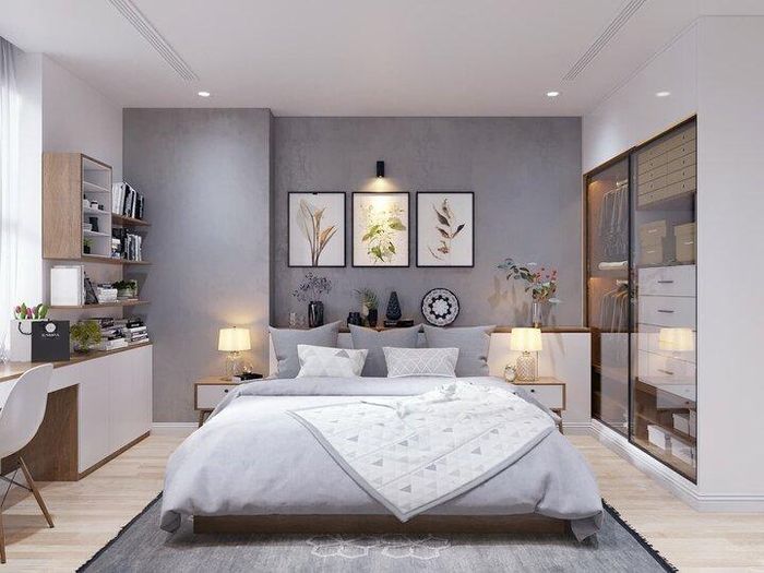 Mẫu phòng ngủ tone màu xám lần này sử dụng tủ áo cánh kính âm tường, mang tới nhiều giá trị thẩm mỹ và tối ưu diện tích. Để tăng thêm phần sáng tạo, những chiếc bình hoa và tranh ảnh trang trí được kết hợp vô cùng khéo léo.