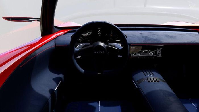  Bên trong xe, Mazda Iconic SP được trang bị nội thất 2 chỗ ngồi. Nội thất dường như được bao phủ bởi da lộn màu xanh đậm với những đường chỉ khâu màu đỏ tương phản trên bảng điều khiển và các tấm cửa. Xe được trang bị bảng đồng hồ kỹ thuật số và màn hình cảm ứng trung tâm tích hợp vào bảng đồng hồ thay vì đặt nổi bật theo xu hướng phổ biến. Cụm điều khiển trung tâm có thiết kế tối giản với những nút đẩy để chuyển số và nút bấm điều chỉnh chức năng. 
