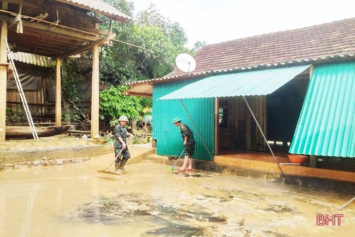 Các cán bộ, chiến sỹ hỗ trợ bà Hoàng Thị Liên ở thôn Trung Tiến, xã Điền Mỹ dọn dẹp vệ sinh sau lũ.