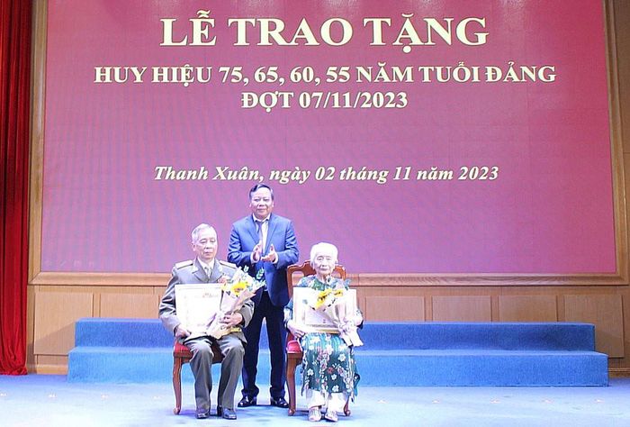 Phó Bí thư Thành ủy Hà Nội Nguyễn Văn Phong trao Huy hiệu 75 năm tuổi Đảng tặng các đảng viên.