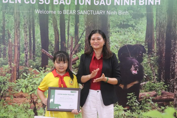 Đại diện cơ sở bảo tồn gấu trao những phần quà ý nghĩa cho các em học sinh tham dự cuộc thi. Ảnh: Đình Minh