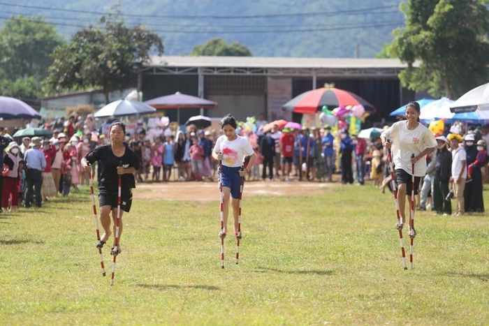Những cô gái nhỏ thoăn thoắt nhanh nhẹn trên đôi chân cà kheo. Ảnh: Văn Ngọc