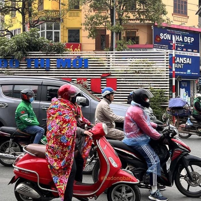 Người điều khiển xe máy này trùm chăn đi đường đã thu hút sự chú ý của người đi đường. Ảnh: #hadongban