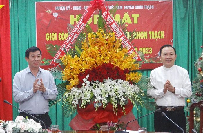 Bí thư Huyện ủy Nhơn Trạch Lê Thành Mỹ tặng lẵng hoa chúc mừng lễ Giáng sinh cho Linh mục Nguyễn Anh Hùng, Hạt trưởng Hạt Phước Lý