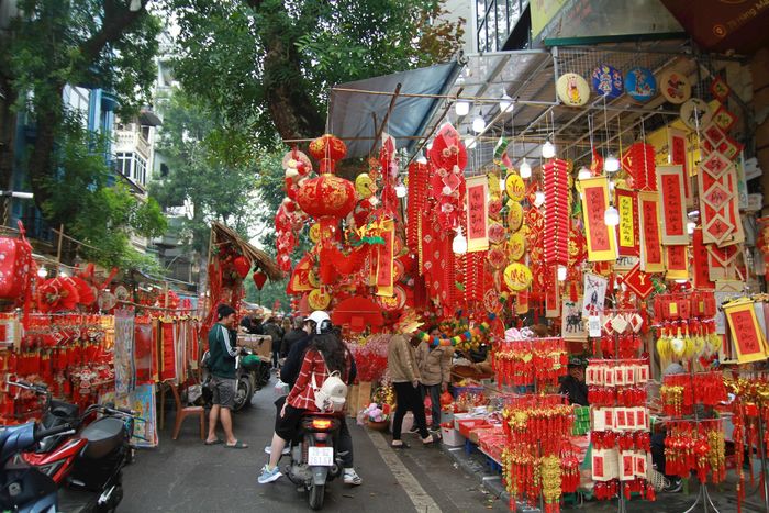 Sắc đỏ ngập tràn từ đầu phố, chủ của một cửa hàng trên phố Hàng Mã chia sẻ: "Năm nay, đồ trang trí Tết Nguyên đán đa dạng về mẫu mã, chủng loại, giá cả rẻ hơn so với mọi năm"