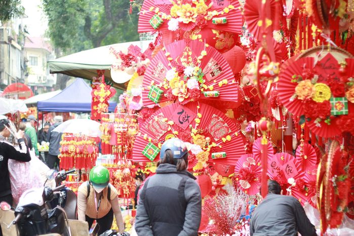 Trên phố rất đông người đã tranh thủ đi mua sắm đồ trang trí cho một cái Tết đầm ấm