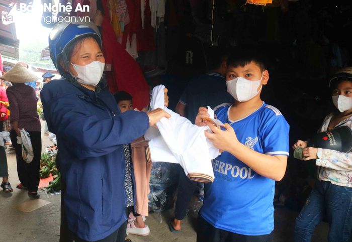  Chợ quê ngày Tết vui hơn khi có nhiều trẻ em theo người thân ra chợ sắm đồ. Một người dân xã Thanh Yên (Thanh Chương) đưa con trai đi chợ mua quần áo mới cho biết: Dịp Tết, gia đình tôi thường mua sắm quần áo mới cho con. Quần áo bây giờ ngày thường không còn thiếu thốn như như xưa, nhưng Tết đến các con vẫn muốn có quần áo mới. Ảnh: Huy Thư 