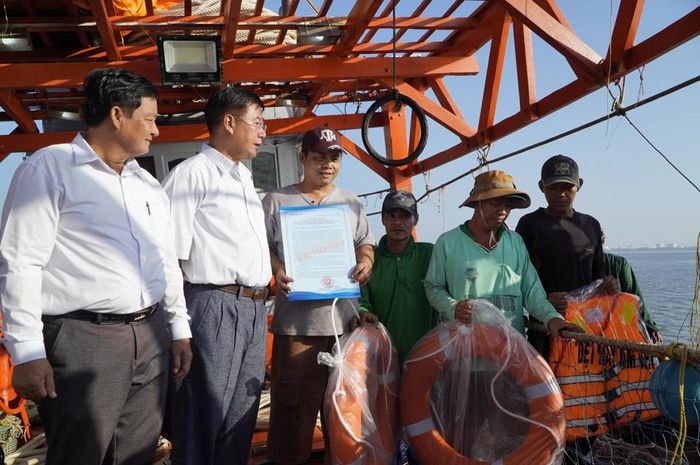 Trao thư kêu gọi của Tỉnh ủy, UBND tỉnh Kiên Giang cho ngư dân đánh bắt đúng quy định, cùng chính quyền gỡ thẻ vàng IUU. (Ảnh PV)