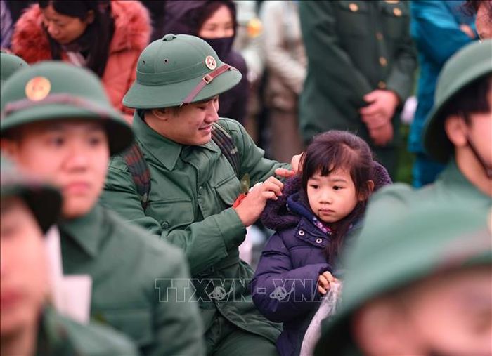 Phút bình yên bên người thân trước giờ lên đường nhập ngũ. Ảnh: Thanh Tùng/TTXVN
