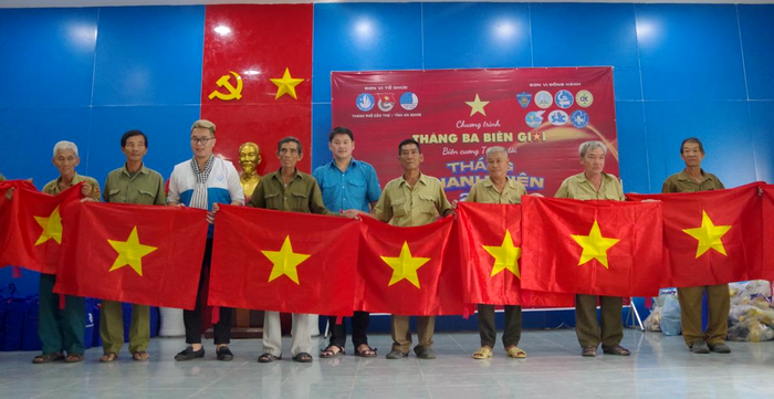 Trao tặng cờ Tổ quốc cho người dân. Ảnh: Tuấn Kiệt
