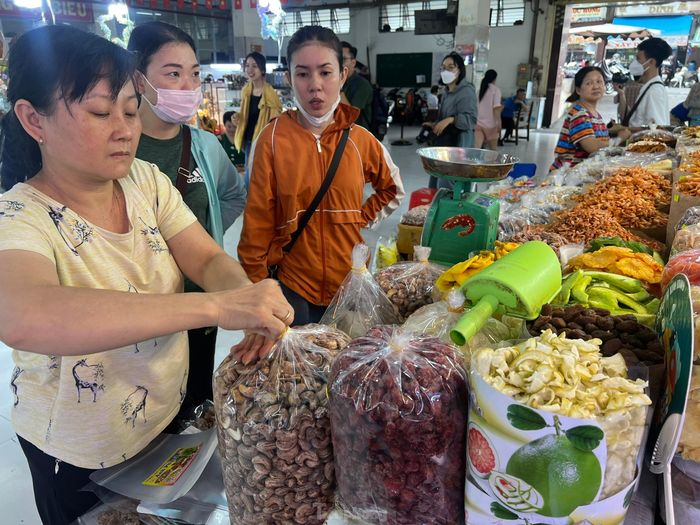 Tiểu thương bày biện hàng hóa ngon mắt chờ khách mua.