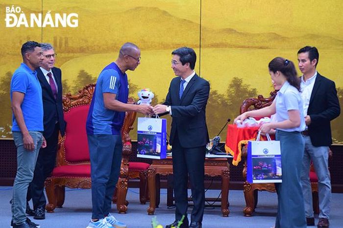 Phó Chủ tịch UBND thành phố Trần Chí Cường (thứ 3, bên phải sang) tặng quà lưu niệm cho các cầu thủ Brazil.