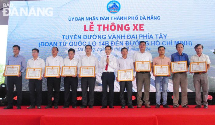 UBND huyện Hòa Vang trao giấy khen cho các hộ dân trên địa bàn có đóng góp tích cực, đồng thuận trong công tác đền bù, giải tỏa tuyến đường. Ảnh: THÀNH LÂN