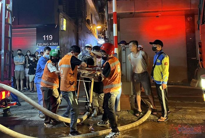 Lực lượng chức năng đưa các nạn nhân trong vụ cháy ra ngoài. Ảnh: T. D.