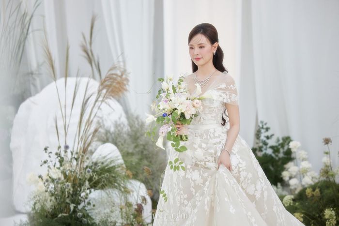 Khác vói các cô dâu khác, Midu lại chọn những phụ kiện đi kèm khá ít và đơn giản. Tuy chỉ dát lên người một vài món cơ bản, nhưng nữ người mẫu vẫn nổi bần bật và sáng ngời ngời. Ngoài ra, Midu còn gây ấn tượng với bó hoa cưới màu trắng mang đến cảm giác thuần khiết.
