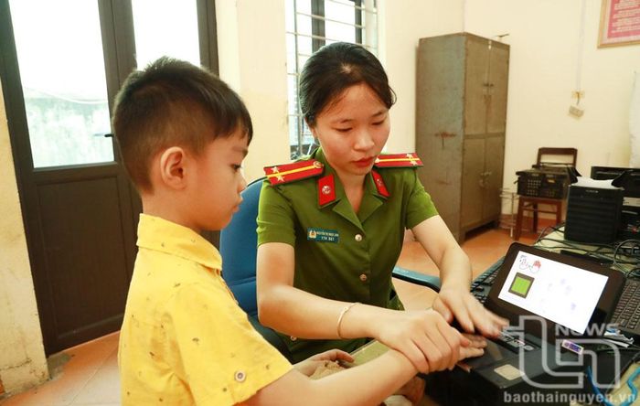 Cán bộ Công an TP. Phổ Yên làm thẻ căn cước cho trẻ em.