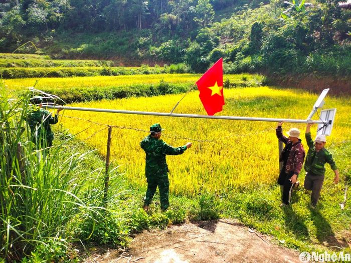Cán bộ Đồn Biên phòng Tri Lễ lắp đặt hệ thống đèn năng lượng mặt trời ở bản Mường Lống, xã Tri Lễ. Ảnh: K.L