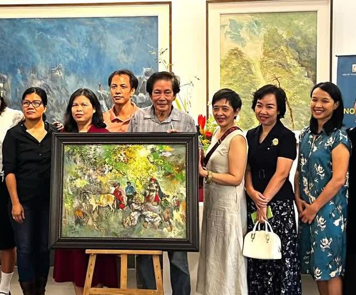 Họa sĩ Đỗ Đức (giữa) chụp ảnh cùng các nhà hảo tâm ủng hộ quỹ “Hoa của đá”