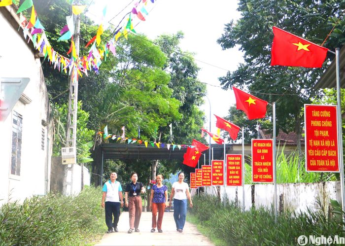 Đoạn đường điện, đường cờ rực rỡ dẫn vào nhà văn hóa xóm Trung Sơn, xã Mường Nọc (Quế Phong). Ảnh: Quỳnh An