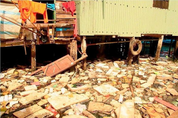 Người dân “khu ổ chuột” nhà rầm sống chung với rác thải. (Ảnh: DC)