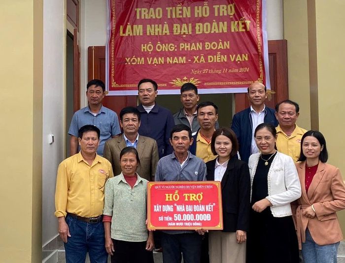 Bàn giao tiền hỗ trợ làm nhà Đại đoàn kết cho gia đình ông Phan Đoàn, xóm Vạn Nam, xã Diễn Vạn. Ảnh: Việt Hà