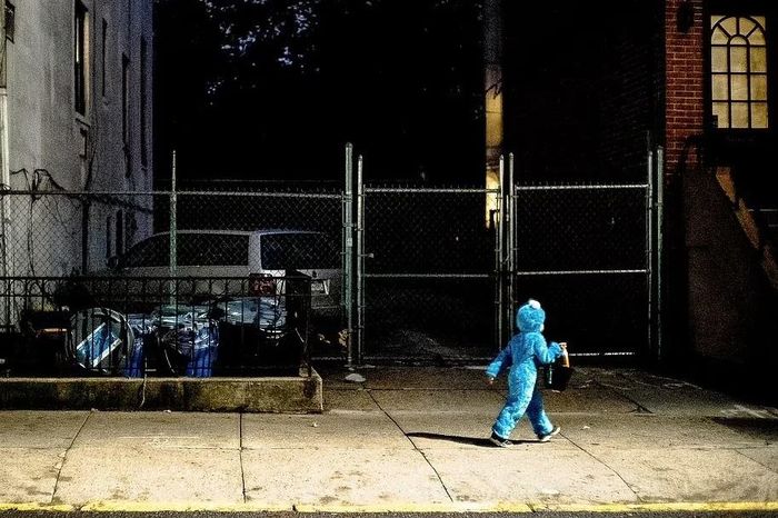  Quái vật Cookie (hay Cookie Monster) là một nhân vật hư cấu nổi tiếng trong chương trình truyền hình giáo dục dành cho trẻ em Sesame Street. Bức ảnh ghi lại cảnh tượng một em bé hóa trang quái vật Cookie đang trên đường trở về nhà ở Cobble Hill. 