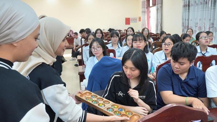  Sinh viên Trường Đại học Kinh tế, Đại học Đà Nẵng khám phá trò chơi dân gian của Malaysia qua sự hướng dẫn của sinh viên Trường Universiti Teknologi Mara. Ảnh: NTCC 