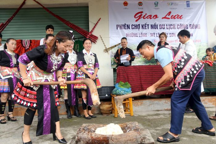 Khách du lịch trải nghiệm làm truyền thống của đồng bào Mông tại Chợ biên Nậm Cắn (Kỳ Sơn). Ảnh: Đào Thọ