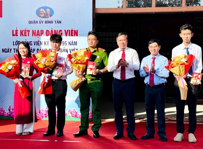  Bí thư Quận ủy quận Bình Tân Huỳnh Khắc Điệp và Trưởng Ban Tổ chức Quận ủy quận Bình Tân Nguyễn Văn Hạnh trao quyết định, tặng hoa 