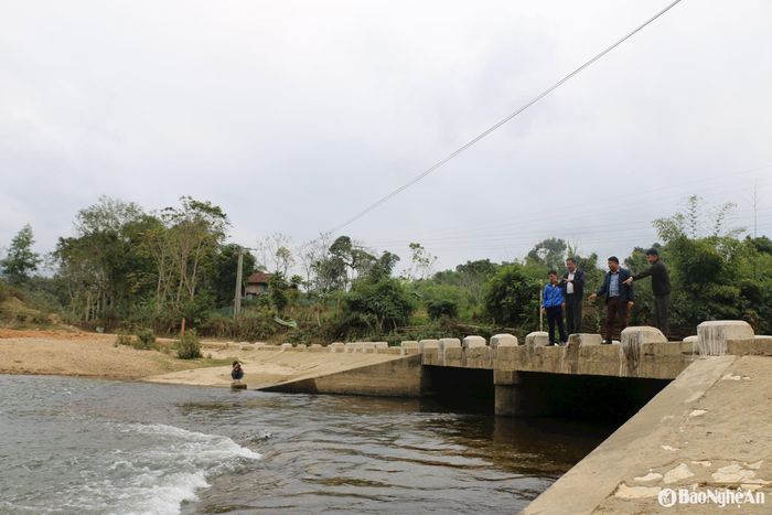 Lãnh đạo xã Châu Phong, cán bộ bản Lìm và ông Hà Văn Thanh trao đổi về công tác cứu hộ, cứu nạn tại cầu tràn bản Lìm. Ảnh: KL