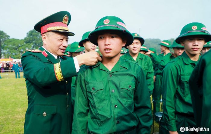 Thượng tướng Lê Quang Minh - Phó Chủ nhiệm Tổng Cục chính trị, Quân đội nhân dân Việt Nam ân cần dặn dò, động viên, căn chỉnh quân tư trang cho các tân binh. Ảnh: Thành Duy