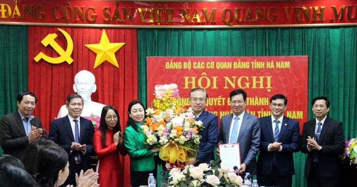 Đồng chí Đinh Thị Lụa, Phó Bí thư Thường trực Tỉnh ủy, Bí thư Đảng ủy các cơ quan Đảng tỉnh trao quyết định và tặng hoa chúc mừng Ban Chấp hành Đảng bộ HĐND tỉnh. Ảnh: Nguyên Khanh