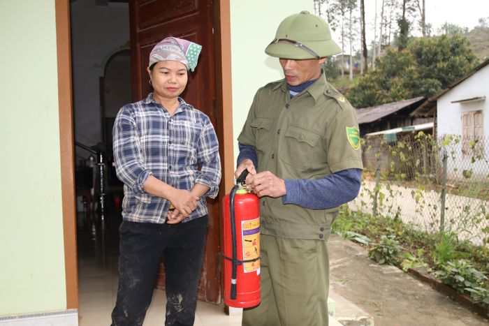 Lực lượng bảo vệ ANTT khu Mận hướng dẫn người dân sử dụng bình chữa cháy