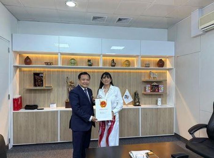  Đại sứ Bùi Văn Nghị trao quà tới Bộ trưởng Bộ Ngoại thương và Du lịch Peru Elizabeth Galdo Marín de Desilú. (Ảnh: Đại sứ quán cung cấp) 