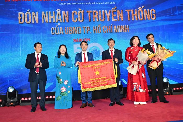 Đồng chí Nguyễn Thị Lệ trao Cờ Truyền thống đến tập thể Báo SGGP