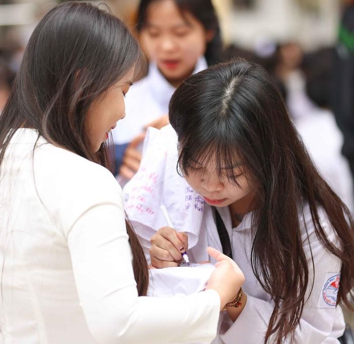 Những dòng lưu bút trên áo trắng học trò mãi là những kỷ niệm đẹp của một thời học sinh. Ảnh: Thanh Tùng - TTXVN