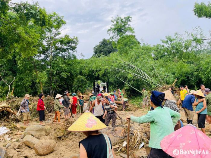 Các lực lượng cùng người dân xã Nhôn Mai khắc phục hậu quả lũ quét. Ảnh: PV