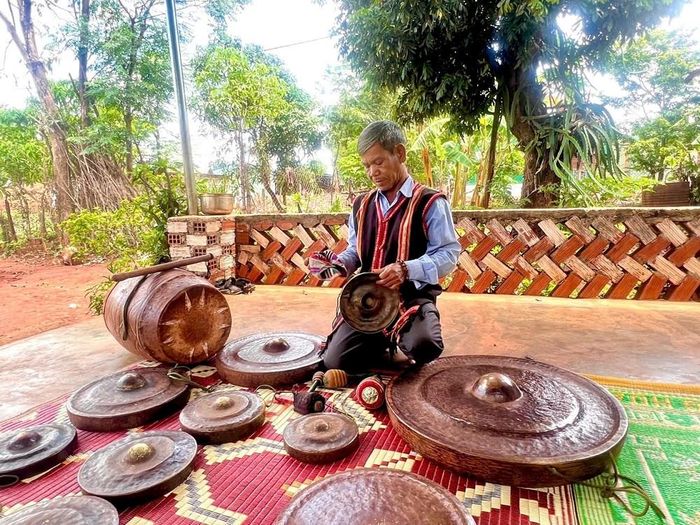 Ông Rơ Mah Khơn cẩn thận gìn giữ bộ cồng chiêng mà mình sưu tầm được
