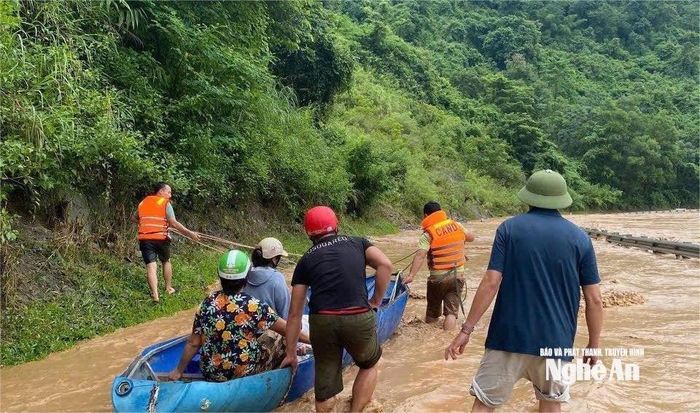 Lực lượng hướng dẫn người dân di chuyển đúng tuyến, tránh băng qua các khu vực nước chảy xiết, đảm bảo an toàn tính mạng và tài sản. Ảnh: CANA