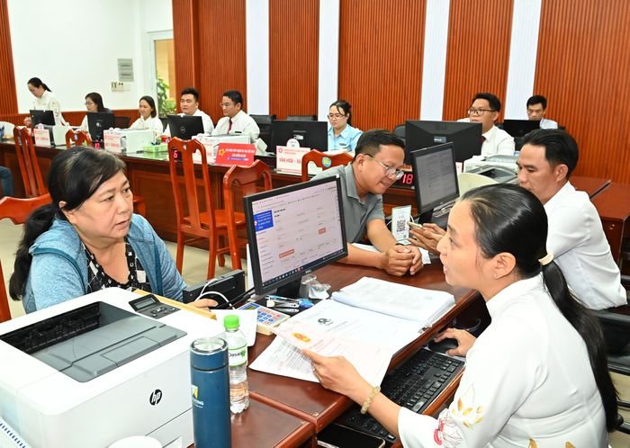  Hướng dẫn người dân làm thủ tục hành chính tại Trung tâm dịch vụ hành chính công phường Tam Bình, TPHCM. Ảnh: VIỆT DŨNG 