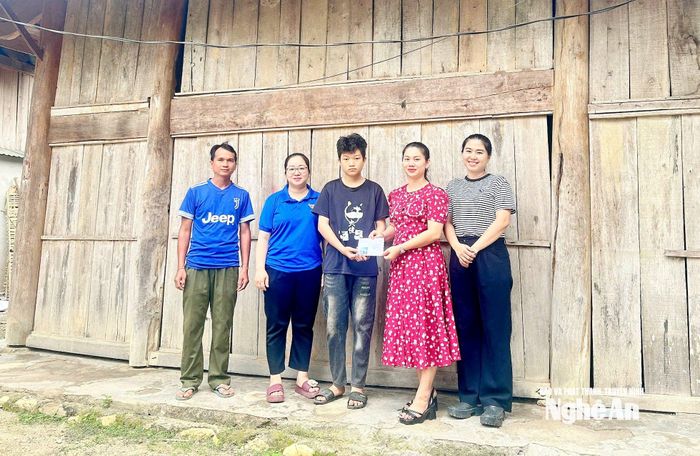Chị Lô Thị Đài Trang trao quà cho học sinh nghèo vượt khó. Ảnh: Công Kiên