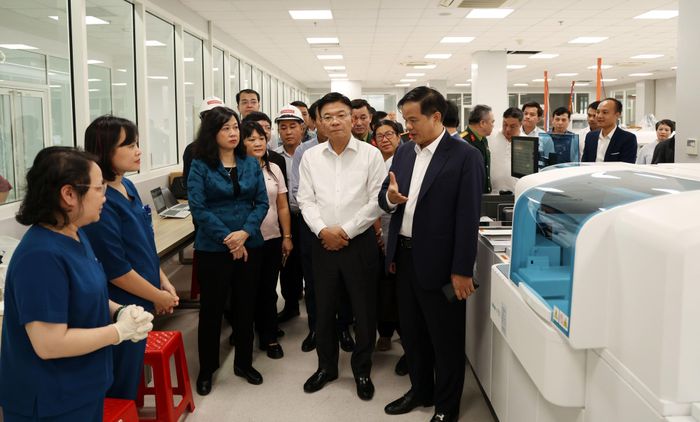 Phó GS.TS Đào Xuân Cơ - Giám đốc Bệnh viện Bạch Mai báo cáo với Phó Thủ tướng Chính phủ Lê Thành Long và Bộ trưởng Bộ Y tế Đào Hồng Lan về nguồn nhân lực của bệnh viện phục vụ công tác khám chữa bệnh tại cơ sở 2 Bệnh viện Bạch Mai.